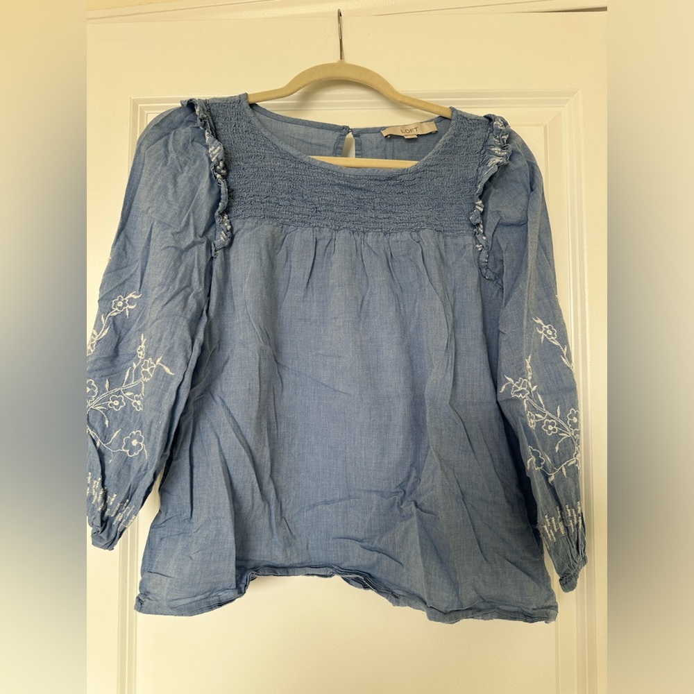 Light denim top with floral embroidery and puffy sleeves